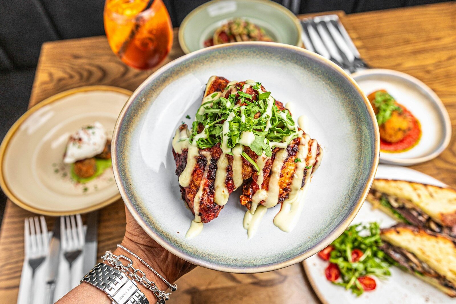 selective focus photography of burger patty, mayonnaise, and French fries served on platter