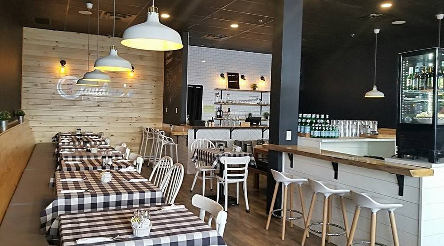 a white plate topped with a salad covered in shrimp